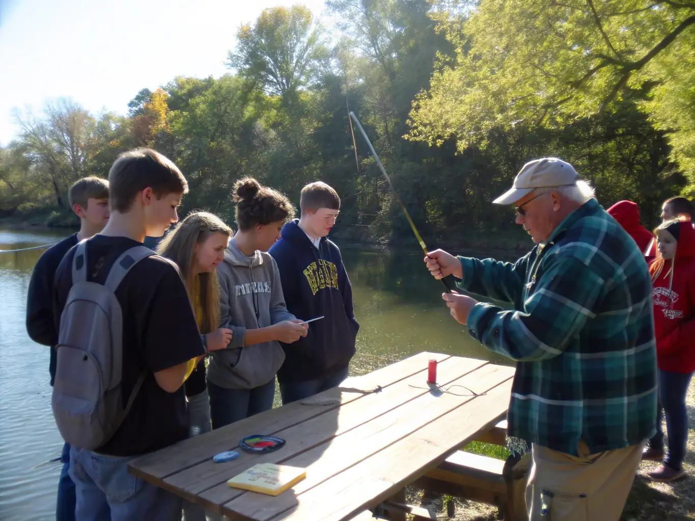 A diverse group of people participating in a fishing workshop, learning about responsible fishing techniques and aquatic conservation. The image should highlight the educational aspect of the program.